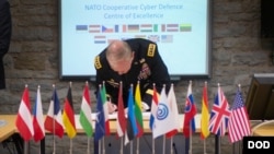 FILE - Gen. Martin E. Dempsey, chairman of the U.S. Joint Chiefs of Staff, signs a guestbook prior to starting a meeting at the NATO Cyber Defense Center of Excellence in Tallinn, Estonia, Sep. 14, 2015. (DoD photo by D. Myles Cullen/Released)