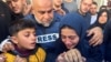 Palestinian journalist Wael Al-Dahdouh embraces family members as they attend the funeral of his son, journalist Hamza Al-Dahdouh, after he was killed in an Israeli strike, in Rafah in the southern Gaza Strip, Jan. 7, 2024.