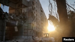 Rescuers work at the site of an apartment building hit by a Russian air strike, amid Russia's attack on Ukraine in Kharkiv, Sept. 24, 2024.