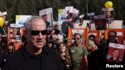 FILE—Israeli Defense Minister Benny Gantz walks as families and supporters of hostages kidnapped in the deadly October 7 attack on Israel by Hamas take part in a march from Reim to Jerusalem as they call for the release of hostages, near Beit Shemesh, Israel, March 1, 2024.