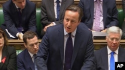 British Prime Minister David Cameron talks to lawmakers in the House of Commons in London during a debate on launching airstrikes against Islamic State extremists inside Syria, Dec. 2, 2015. The parliamentary vote is expected Wednesday evening. 