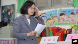 Taiwanese President Tsai Ing-wen waits to cast her ballot, Nov. 24, 2018, in Taipei, Taiwan. Taiwanese began voting in midterm local elections Saturday seen as a referendum on Tsai's independence-leaning administration, amid growing pressure from China.