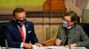 Iowa Secretary of State Paul Pate, left, and Iowa Gov. Kim Reynolds tally the votes cast by members of Iowa's Electoral College, Dec. 14, 2020, at the Statehouse in Des Moines, Iowa.