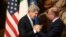 Italy's Prime Minister Enrico Letta (R) welcomes U.S. Secretary of State John Kerry during a meeting in Rome, Oct. 23, 2013. 