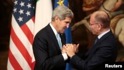 Italy's Prime Minister Enrico Letta (R) welcomes U.S. Secretary of State John Kerry during a meeting in Rome, Oct. 23, 2013. 