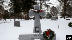 FILE - A wreath adorns a headstone for Michael Karkoc at Hillside Cemetery in Minneapolis, Jan. 21, 2020. 