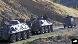 FILE - Turkish soldiers in armored vehicles patrol in Sirnak province on the Turkish-Iraqi border, October 21, 2011.