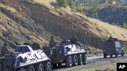 Turkish soldiers in armored vehicles patrol in Sirnak province on the Turkish-Iraqi border, October 21, 2011.