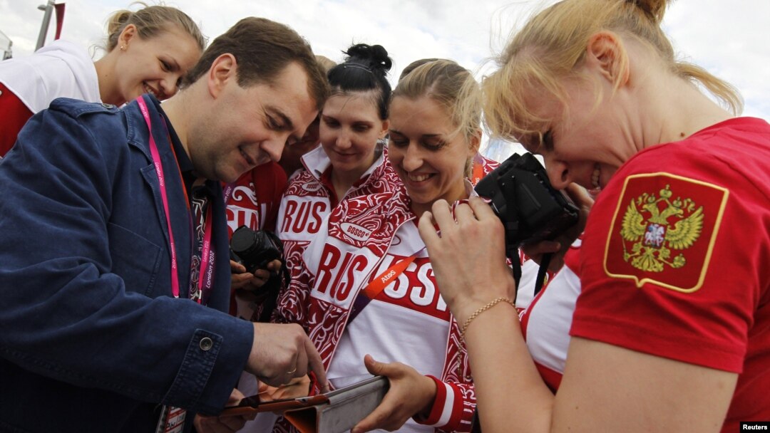 Russia's Prime Minister Dmitry Medvedev (L) meets with members of the Russian Olympic team as he visits the Olympic Village at the London 2012 Olympic Games in London July 28, 2012.