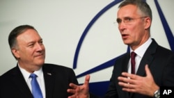 U.S. Secretary of State Mike Pompeo, left, is welcomed by NATO Secretary General Jens Stoltenberg after arriving for a NATO Foreign Ministers meeting at the NATO headquarters in Brussels, Nov. 20, 2019. 