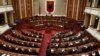 FILE - Albania's Prime Minister Edi Rama delivers a speech to the parliament with the seats of the main opposition Democratic party, left, empty, during an assembly session in Tirana, Feb. 23, 2017.