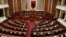 FILE - Albania's Prime Minister Edi Rama delivers a speech to the parliament with the seats of the main opposition Democratic party, left, empty, during an assembly session in Tirana, Feb. 23, 2017.