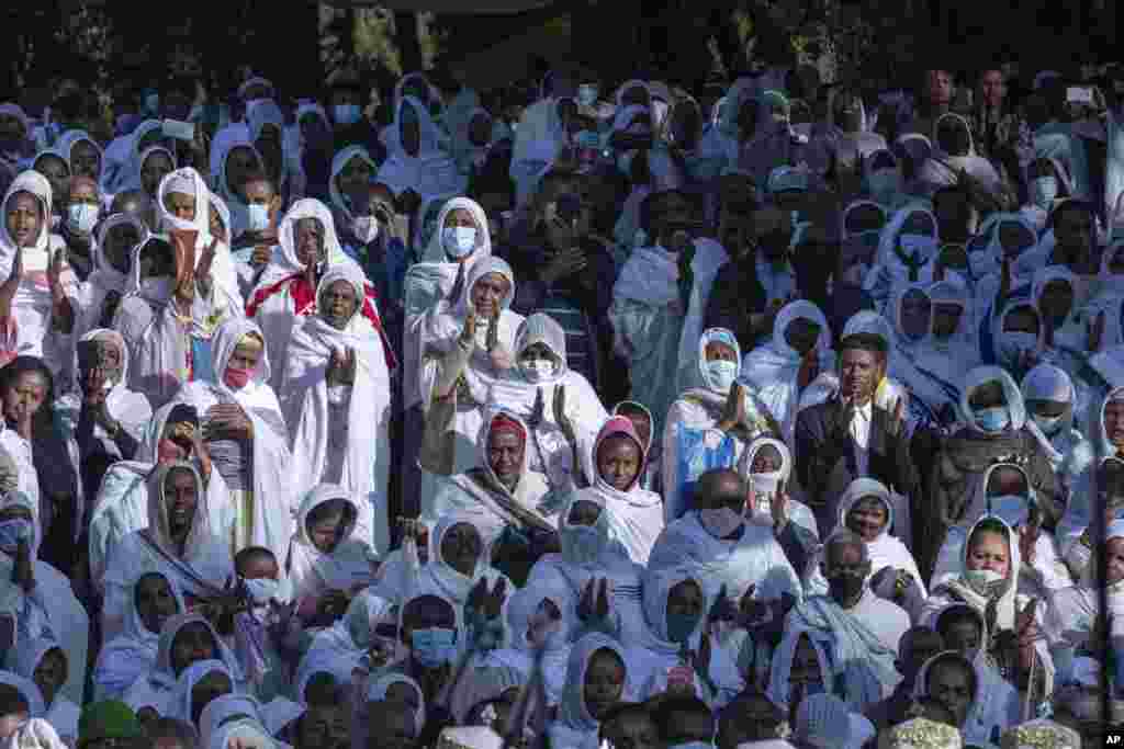 Pilgrims look on during a Mass service for Ethiopian Christmas at the Bale-wold Church, in Addis Ababa.