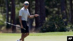 President Barack Obama reacts after putting on the first green as he plays golf at Farm Neck Golf Course in Oak Bluffs, Mass., on Martha's Vineyard, Aug. 7, 2016.