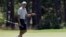 President Barack Obama reacts after putting on the first green as he plays golf at Farm Neck Golf Course in Oak Bluffs, Mass., on Martha's Vineyard, Aug. 7, 2016.