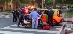 FILE - Emergency paramedics treat victims of a shooting in the Columbia Heights neighborhood of Washington, D.C., in May 2020. The nation's capital has seen a rise in gun violence since the start of the coronavirus pandemic. (Chris Simkins/VOA)