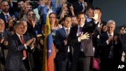 Venezuela's Juan Guaido waves at audience members before speaking at a rally in Miami, Feb. 1, 2020.