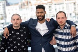 Actors Damien Bonnard, from left, Djebril Zonga and Alexis Manenti pose for photographers at the photo call for the film 'Les Miserables' at the 72nd international film festival, Cannes, southern France, May 16, 2019.