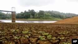 FILE — The almost dry water reservoir of Combani is visible, on the French Indian Ocean territory of Mayotte, October 10, 2023. The government is pinning its hopes on the upcoming rainy season, though residents say it won't be enough to fix the deep-seated water problems.