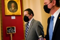 FILE - Rep. Jamie Raskin, D-Md., left, walks with Rep. Adam Schiff, D-Calif., on Capitol Hill in Washington, Jan. 13, 2021.