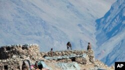 FILE - This photograph provided by the Indian Army, according to them shows Chinese troops dismantling their bunkers at Pangong Tso region, in Ladakh along the India-China border on Monday, Feb.15, 2021. 