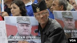 Para pendukung melakukan protes atas pengadilan Mladic dengan membawa poster Ratko Mladic.