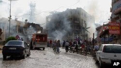 Firefighters work at one explosion site in Reyhanli, near Turkey's border with Syria, May 11, 2013.