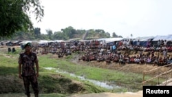 FILE - A Bangladeshi soldier stands guard near a refugee camp in Cox's Bazar, Bangladesh, housing Rohingya refugees from Myanmar's Rakhine state, April 29, 2018.