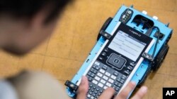 A student uses a Texas Instruments calculator at C.E. Williams Middle School, May 22, 2018 in Charleston, South Carolina.