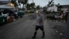 Robert Turick, 68, walks on his street as he and other neighbors work to remove debris swept onto their properties by Hurricane Milton's storm surge, in Englewood, Florida, on Oct. 11, 2024.