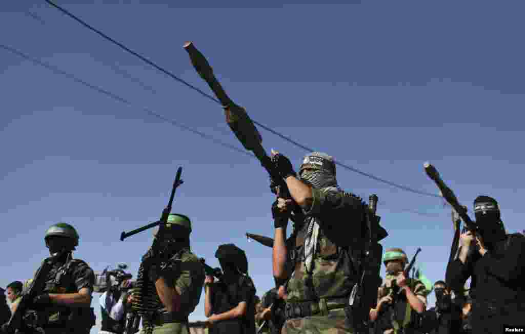 Palestinian members of the al-Qassam brigades, the armed wing of the Hamas movement, stand guard as they wait for the arrival of Hamas chief Khaled Meshaal in Rafah in the southern Gaza Strip, December 7, 2012. 