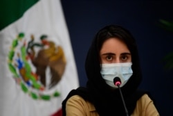 An Afghan woman, member of the Afghanistan Robotic team, is seen during a press conference after her arrival to Mexico after asking for refuge, at the Benito Juarez International Airport in Mexico City, on August 24, 2021.