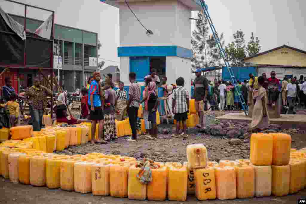 Residents gather to collect water as they line up their jerrycans at a water point amid a shortage of water in Goma, Democratic Republic of Congo.