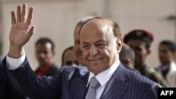 FILE - Yemen's then Vice President Abed Rabbo Mansour Hadi waves as he enters a polling center in 2012. There are conflicting reports about the whereabouts of Hadi, who is now Yemen's president.