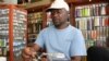 Fly tying maestro Elpheus Ndlovu behind his vice, creating a grasshopper pattern. (Darren Taylor for VOA News)