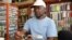 Fly tying maestro Elpheus Ndlovu behind his vice, creating a grasshopper pattern. (Darren Taylor for VOA News)