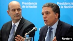 Argentina's Treasury Minister Nicolas Dujovne, right, speaks next to Argentina's Central Bank President Federico Sturzenegger during a news conference in Buenos Aires, Argentina, June 7, 2018.