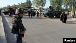 FILE - A member of Iraqi security forces stands guard in Baghdad's Kadhimiya district, May 2, 2016. Fearing a repeat of last week's turmoil when protesters stormed into the fortified Green (International) Zone, Baghdad was on lockdown Friday. 