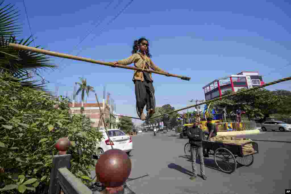 Maria, seorang gadis berusia enam tahun dari negara bagian Chhattisgarh, memamerkan keterampilan berjalan di atas tali untuk menarik sedekah dari orang-orang di pinggir jalan di Prayagraj, Uttar Pradesh, India. (AP)&nbsp;