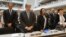 Delegate stands for a minute of silence in memory of the deceased health workers at the World Health Organization (WHO) assembly, May 18, 2015, Geneva.  