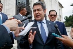 FILE - Honduran President Juan Orlando Hernandez answers questions from the Associated Press, August 13, 2019, as he leaves a meeting of the Organization of American States, in Washington.