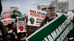 For the eighth day in a row, people hold banners as they demonstrate against police brutality in Lagos, Nigeria, Oct. 15, 2020.