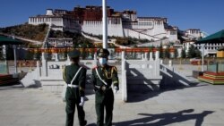 Paramilitary police officers swap positions during a change of guard in front of Potala Palace in Lhasa, during a government-organized tour of the Tibet Autonomous Region on October 15, 2020. (Thomas Peter/Reuters)