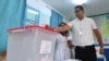 A Tunisian voter casts his ballot at a polling station in Tunis during the North African country's presidential election on Oct. 6, 2024. Tunisians cast ballots in a presidential election, with incumbent Kais Saied expected to secure victory. 