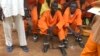 This undated photo shows prisoners sitting together at the central prison in the capital Juba, South Sudan. A new Amnesty International report accuses authorities in South Sudan of torturing people to death in detention and letting many others languish.