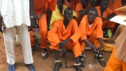 FILE- This undated photo shows prisoners sitting together at the central prison in the capital Juba, South Sudan. An Amnesty International report accuses authorities in South Sudan of torturing people to death in detention and letting many others languish for long periods without trial. 