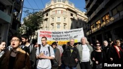 Protesters shout slogans during a demonstration marking a 24-hour strike of the country's biggest public sector union ADEDY against planned tax and pension reforms in Athens, Greece, Nov. 24, 2016. 