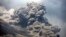Mount Sinabung releases pyroclastic flows during an eruption as seen from Payung village, North Sumatra, Indonesia, Feb. 3, 2014.