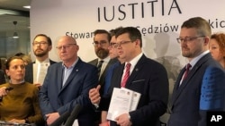 Judges of the Iustitia association release a report listing dozens of judges and prosecutors who are facing reprisals for questioning changes the right-wing government is making to the court system, in Warsaw, Poland, Feb. 29, 2020.