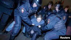 Punk protest band Pussy Riot member Maria Alyokhina is detained by police at a protest in central Moscow February 24, 2014.